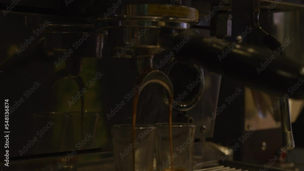 Coffee machine in coffee shop filling two shot glasses of espresso Coffee machine in coffee shop filling two shot glasses of espresso