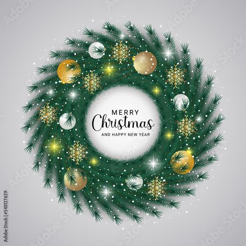 Christmas wreath green leaf with a white ornament with gold ball and snow