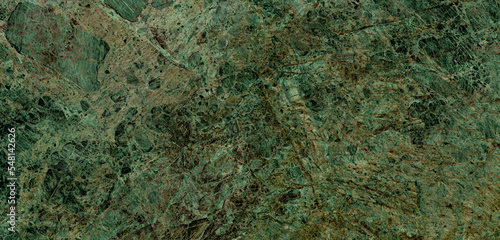 forest green emperador marble stone background with thin vines on surface. luxurious green marble granite for kitchen interior decor, wallpaper, ceramic slab tile and vitrifield tiles. limestone decor