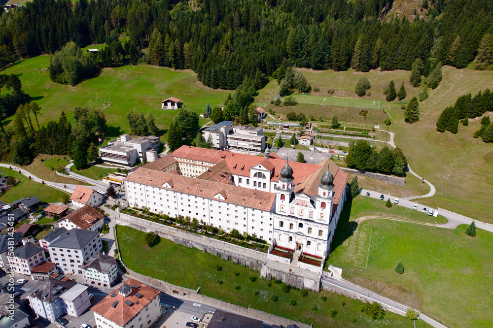 Aerial view of Cloister Disentis, Canton Graubünden, at alpine village in the Swiss Alps on a sunny late summer day. Photo taken September 5th, 2022, Disentis, Switzerland.