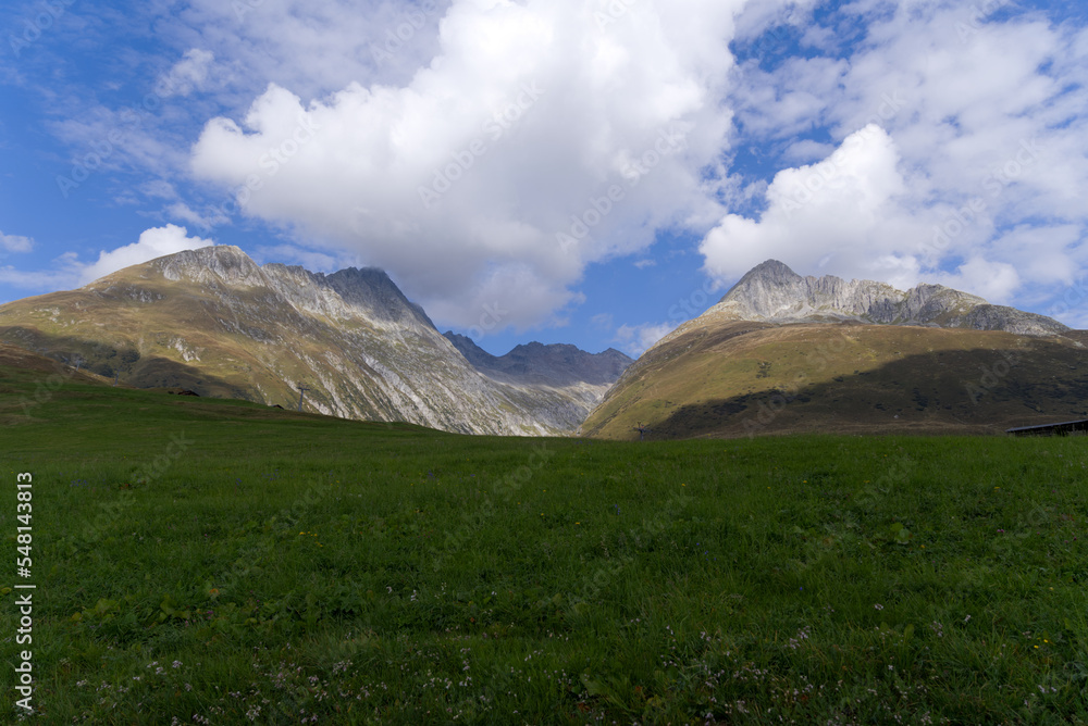 Fototapeta premium Mountain panorama with peak at Swiss mountain pass Oberalppass on a sunny late summer morning. Photo taken September 5th, 2022, Oberalp Pass, Switzerland.