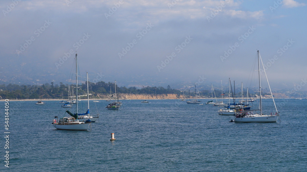 Fototapeta premium Sailboats standing in front of the coast of Santa Barbara, California, near Stearns Wharf.