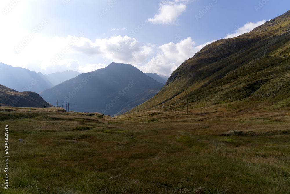 Scenic landscape in the Swiss Alps at region of Swiss mountain pass Oberalppass on a blue cloudy late summer day. Photo taken September 5th, 2022, Oberalppass, Switzerland.