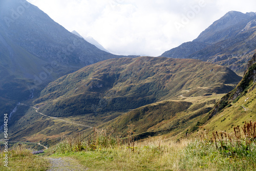 Hiking trail with scenic landscape at region Oberalppass Surselva on a blue cloudy late summer day. Photo taken September 5th, 2022, Oberalp Pass, Switzerland.