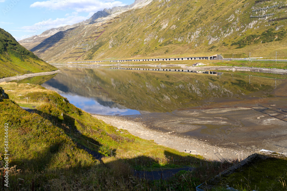 Beautiful landscape at Oberalppass with lake and reflections of mountain panorama on a sunny late summer day. Photo taken September 5th, 2022, Oberalp Pass, Switzerland.