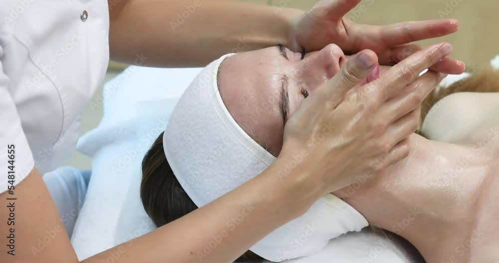 Very beautiful girl doing facial massage at the spa salon. Healthy lifestyle. Very beautiful girl doing facial massage at the spa salon. Healthy lifestyle.