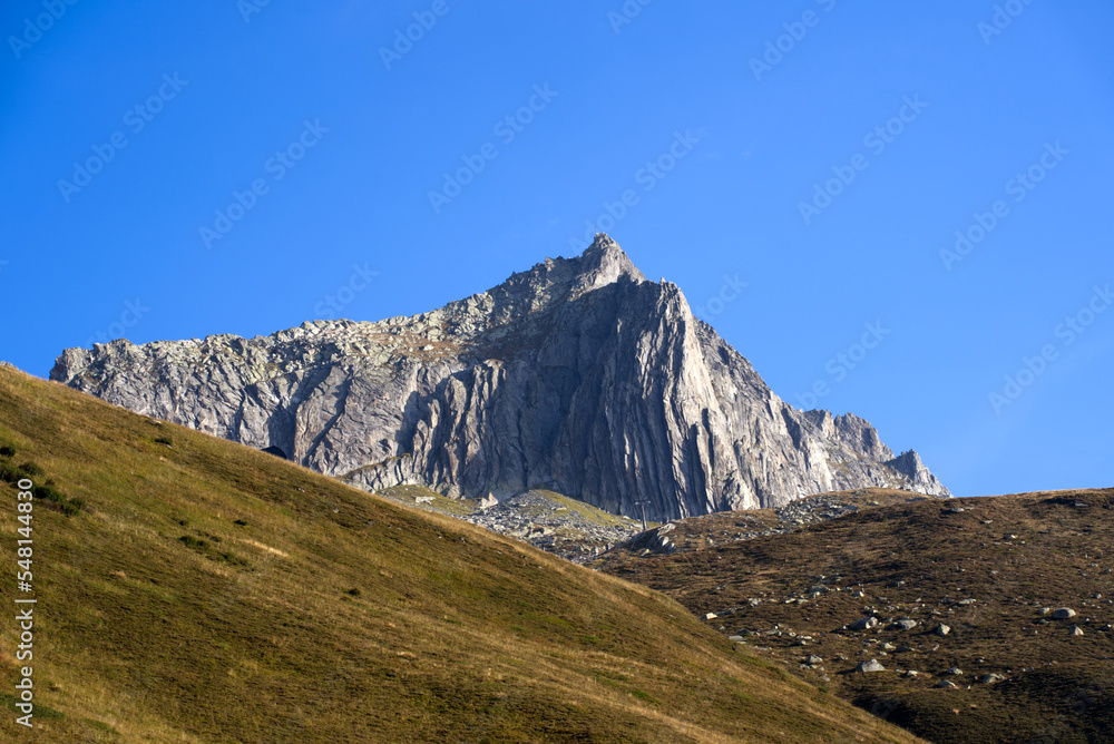 Mountain panorama with peak at Swiss mountain pass Oberalppass on a sunny late summer morning. Photo taken September 5th, 2022, Oberalp Pass, Switzerland. Mountain panorama with peak at Swiss mountain pass Oberalppass on a sunny late summer morning. Photo taken September 5th, 2022, Oberalp Pass, Switzerland.