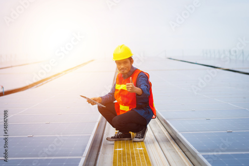 Photovoltaic Technology, Service Engineer Checking Solar Rooftop Installation of Factory Morning Silhouette Technician Checking and Repairing Solar Rooftop of Factory.