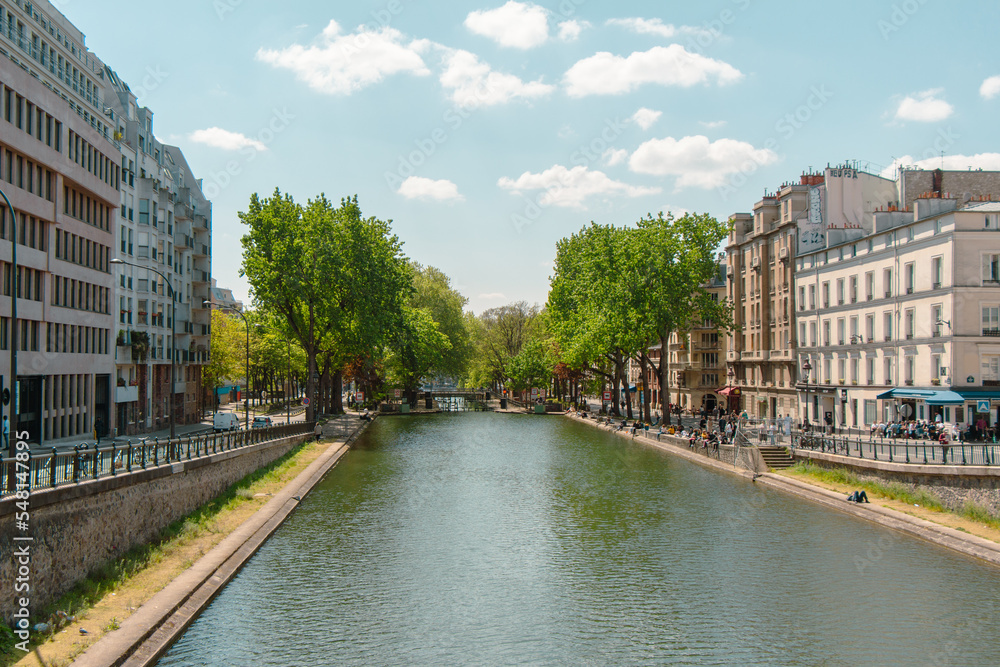 Panoramic view of the famous Canal Saint Martin, with people on its shores Paris, France.