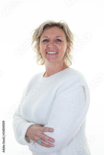 Attractive senior woman blond friendly standing with folded arms crossed in white background