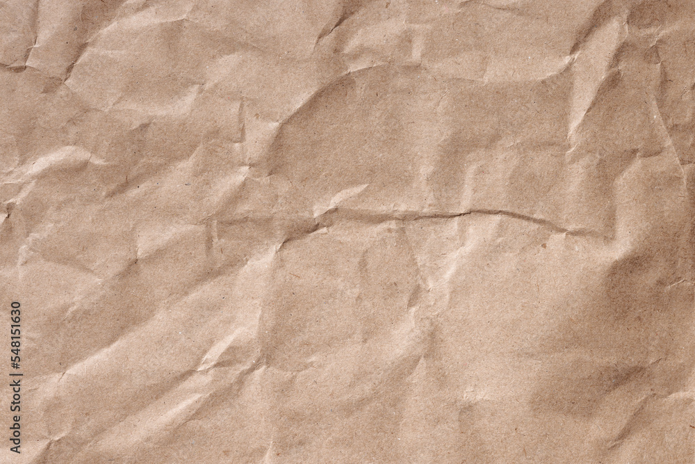 Fototapeta premium Crumpled brown recycled wrapping paper. Background texture.