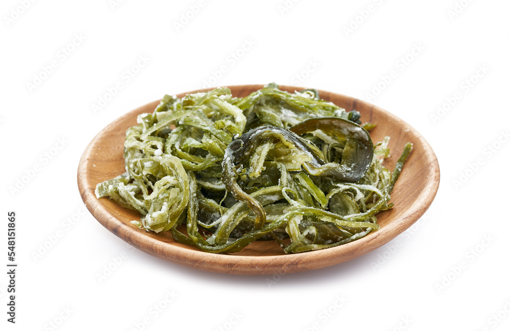heap of fresh Korean salted seaweed salad stem side dish or Miyeok Julgi Bokkeum in wood bowl isolated on white background. Laminaria or Kelp Seaweed stem                              