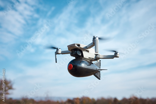 drone with a bomb for fishing on board flies in the sky
