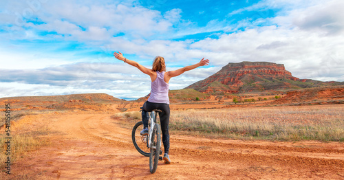 Active woman biking in Spain Aragon countryside ( sierra armantes)