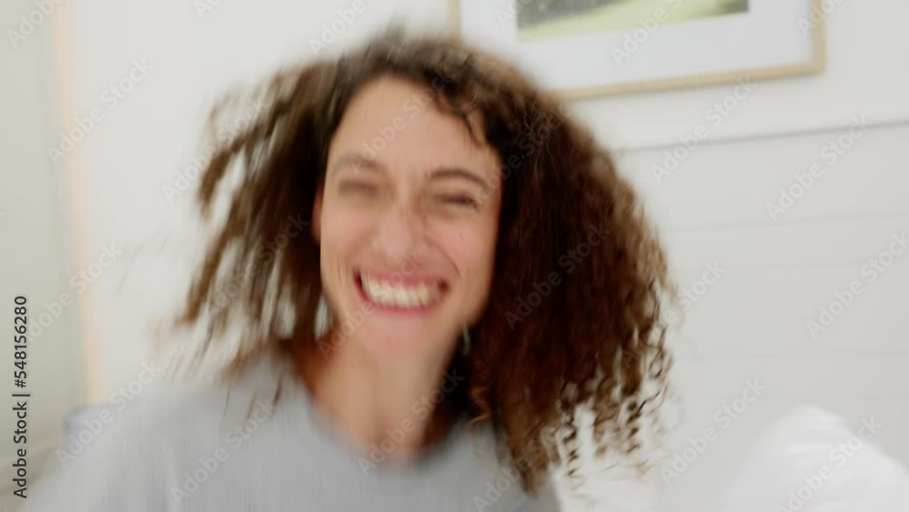 Happy, woman and pillow fight playing in the bedroom for joyful fun, game or bonding together indoors. Portrait of female enjoying play fighting with pillows in bed with smile and laugh in happiness Happy, woman and pillow fight playing in the bedroom for joyful fun, game or bonding together indoors. Portrait of female enjoying play fighting with pillows in bed with smile and laugh in happiness