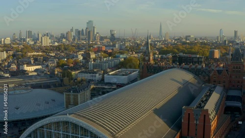 Slow aerial shot towards St Pancras clock tower with London skyline in the background photo