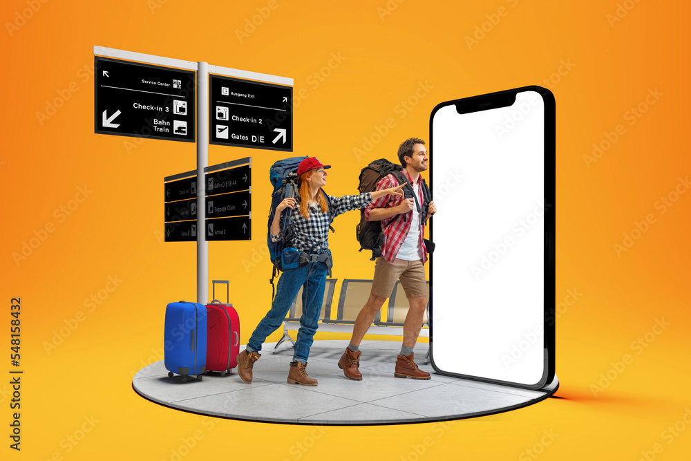 At airport. Happy young couple, smiling man and woman going to summer vacation trip using 3d model of phone isolated on orange background. - obrazy, fototapety, plakaty 