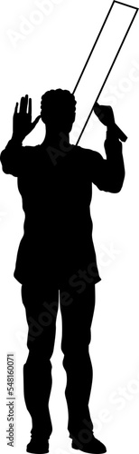 Protestor or demonstrator at a demonstration march, picket line or strike protest rally in silhouette. Holding up a banner or picket sign board placard.
