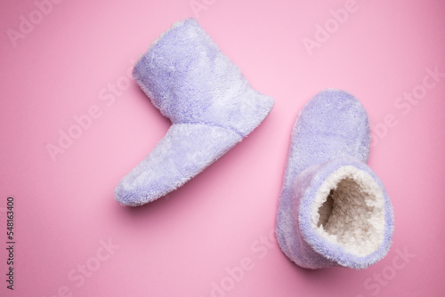 Soft blue homemade ugg boots on a pink background.
