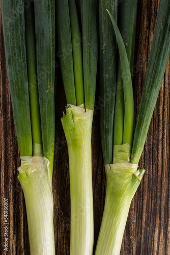 green onions on wooden background