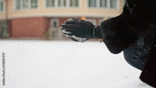 close-up female hands make a snowball. snow games.