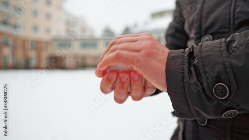 close-up male hands make a snowball. snow games.