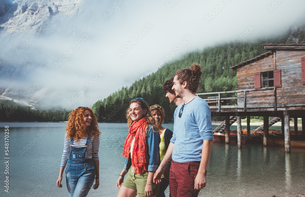 Group of teens spending time on the lake beach