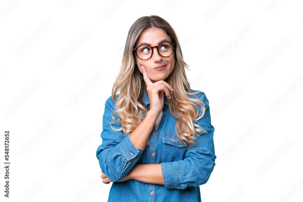 Young Uruguayan woman over isolated background thinking an idea while looking up Young Uruguayan woman over isolated background thinking an idea while looking up