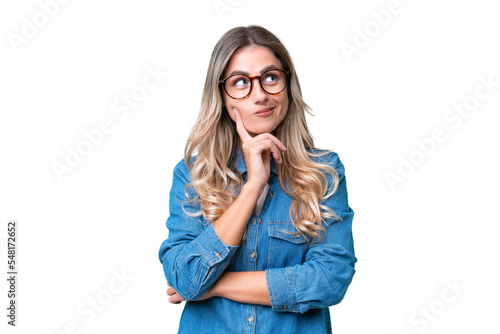 Young Uruguayan woman over isolated background thinking an idea while looking up photo