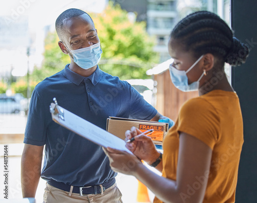 Sign, covid and black woman with a delivery at the door with a happy delivery man in a face mask for safety compliance. Ecommerce, coronavirus and African girl customer with a clipboard for a box