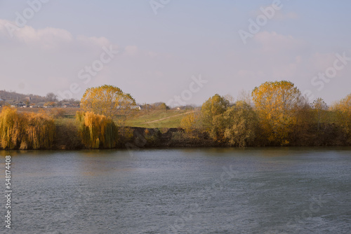 Picturesque river landscape with a green bank