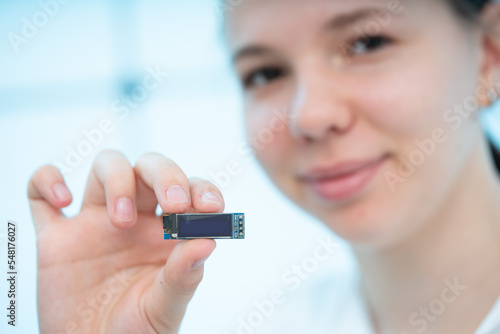 miniature liquid crystal display LCD with organic light-emitting diode  LED  backlight in the hands of a young woman