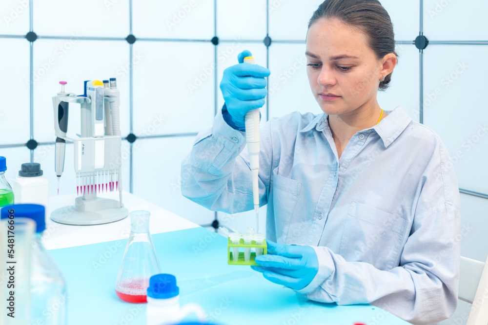 female laboratory assistant in microbiology laboratory use centrifuge for biological samples female laboratory assistant in microbiology laboratory use centrifuge for biological samples