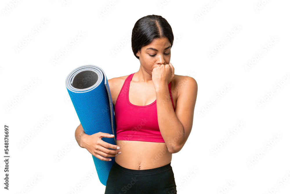 Young sport African American woman going to yoga classes while holding a mat over isolated background having doubts Young sport African American woman going to yoga classes while holding a mat over isolated background having doubts