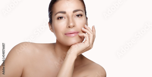 Beautiful middle-aged model in a skincare concept. Beauty panorama banner with lateral white copyspace