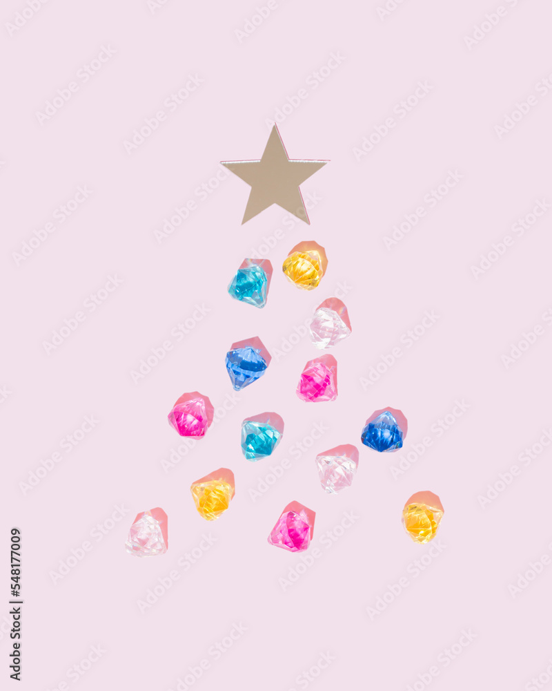 Colorful diamonds on pink background with mirror star. Christmas tree aesthetic decoration. Jewelry concept.