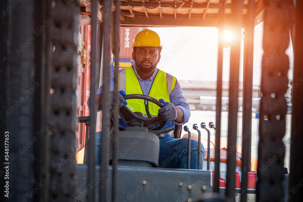 Foreman working at container stock yard with drive a loader forklift steering wheel control for transport handling. Foreman working at container stock yard with drive a loader forklift steering wheel control for transport handling.
