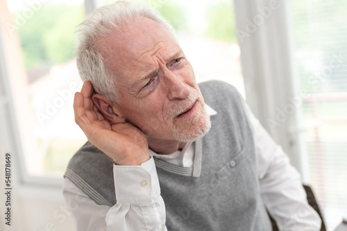 Senior man with hearing problems