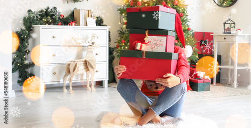 Teenage girl with Christmas gifts at home