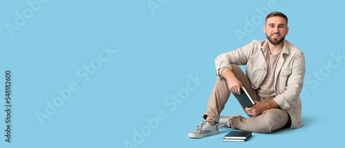 Young man with books on lig...