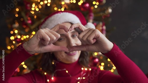 white woman face view through heart shape joined fingers, blogger share love photo