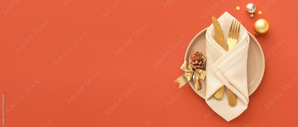 Fototapeta premium Beautiful Christmas table setting on orange background with space for text