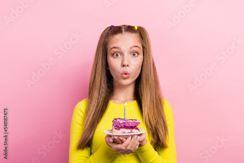 Photo of excited shiny schoolgirl wear yellow top having birthday wish holding cake piece plate isolated pink color background