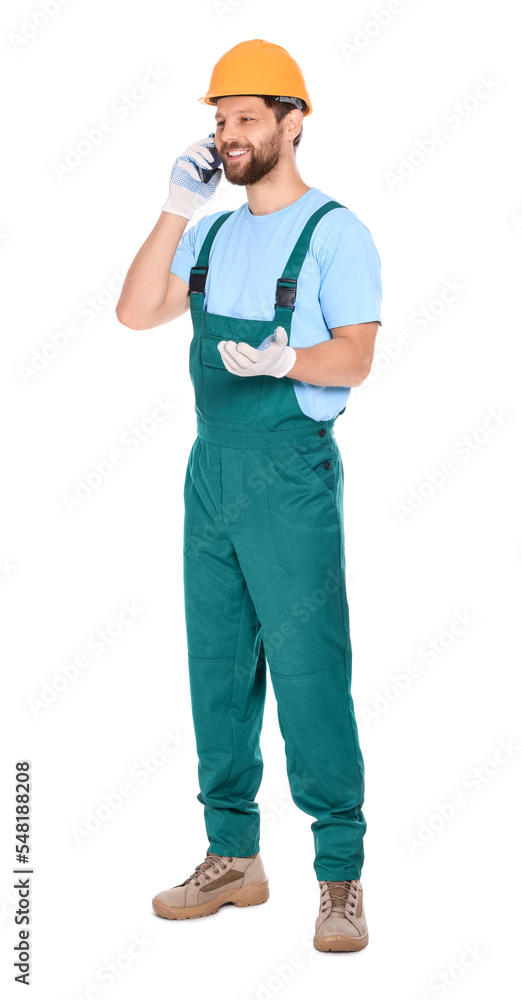 Professional repairman in uniform talking on smartphone against white background Professional repairman in uniform talking on smartphone against white background