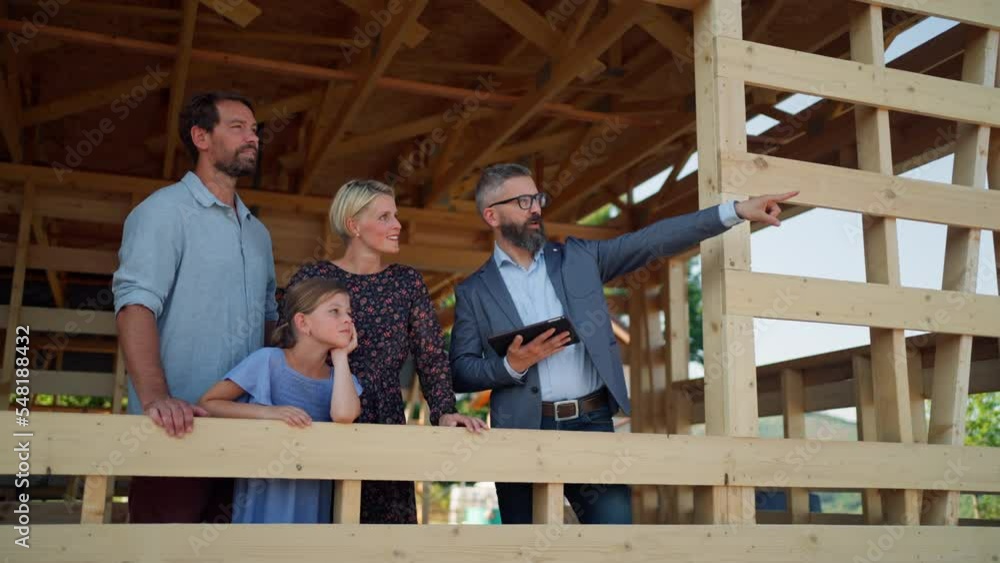 Family consulting new home with real estate agent on building site. Family consulting new home with real estate agent on building site.