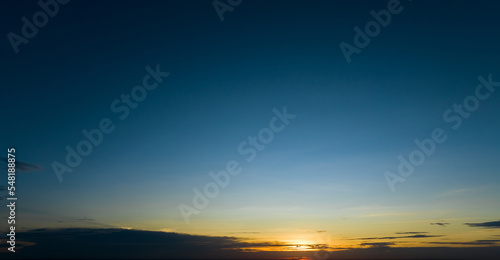 Dramatic golden and dark blue sunset sky abstract background. Dark blue sky in the evening. Sky at dusk. Sunset abstract background. Dusk and dawn concept. Beauty in nature.Majestic sky for wallpaper. © Artinun
