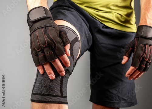Картината върху платно Athlete wearing knee support brace, elastic kneecap bandage, orthopedic sleeve f