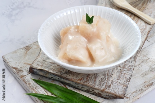 Singkong Thailand or delicious sweet cassava, popular dessert from Thailand, served with coconut milk and pandanus leaves