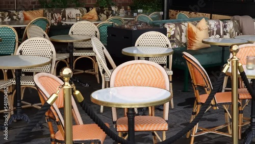 Sidewalk cafe  with small round tables and empty chairs - coffeehouse, coffee shop, diner or restaurant.
