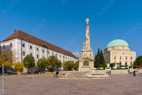 view of the Szechenyi Square in downtown Pécs with the Holy Trinity Statue and the Pasha Qasim Mosque